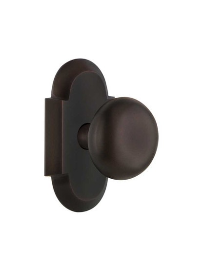 Arched Rosette Door Set with Classic Round Knobs in Timeless Bronze.